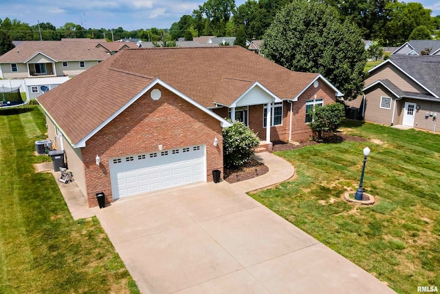 view of front of property featuring a front lawn, central AC unit, and a garage