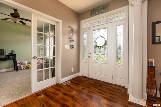 carpeted foyer featuring decorative columns and ceiling fan