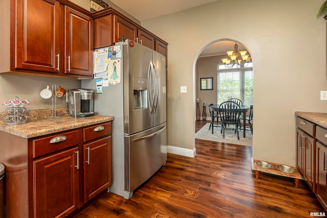 kitchen featuring a chandelier, stainless steel fridge, light stone countertops, and dark hardwood / wood-style floors