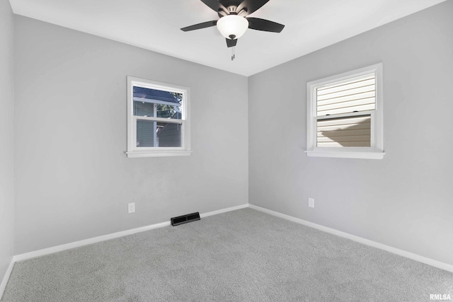 carpeted spare room with ceiling fan