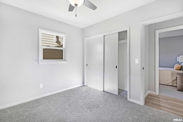 unfurnished bedroom with carpet flooring, ceiling fan, and a closet