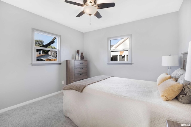 bedroom with carpet flooring, multiple windows, and ceiling fan