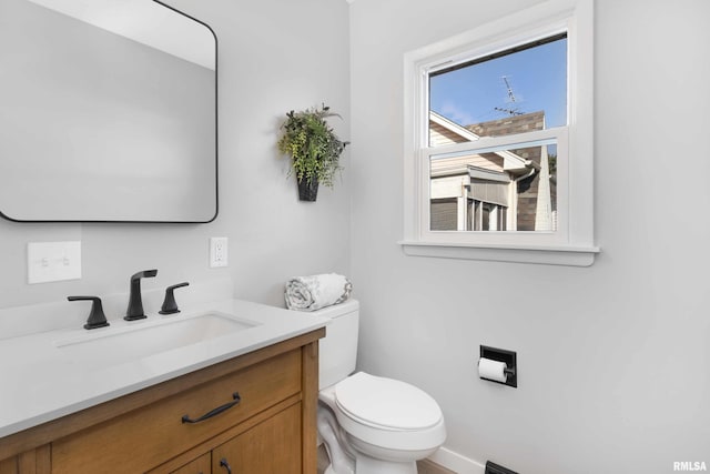 bathroom with toilet and vanity