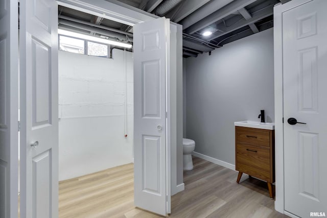 bathroom featuring vanity, toilet, and wood-type flooring