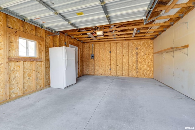 garage with white refrigerator and a garage door opener