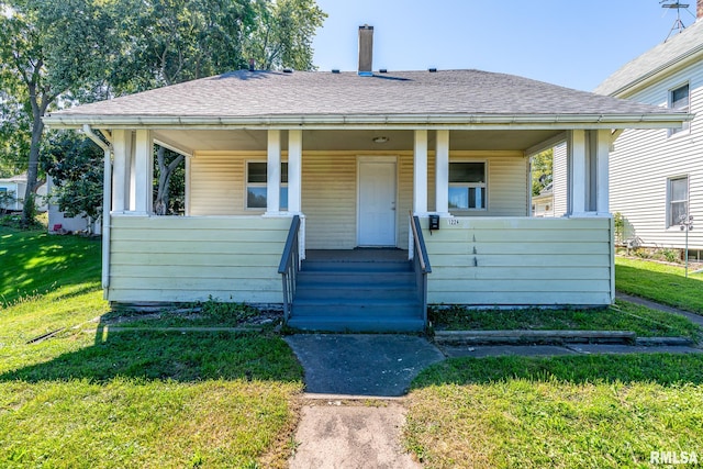 bungalow-style house with a front yard and a porch