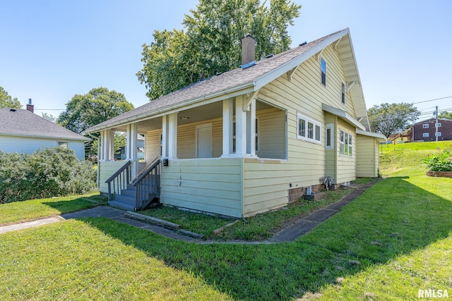 bungalow-style home with a front lawn