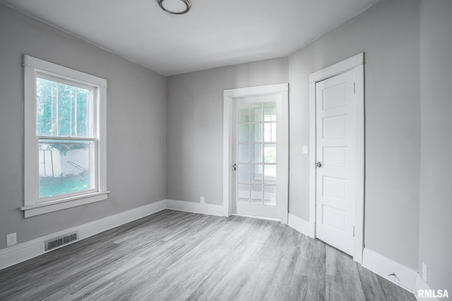 empty room with hardwood / wood-style flooring