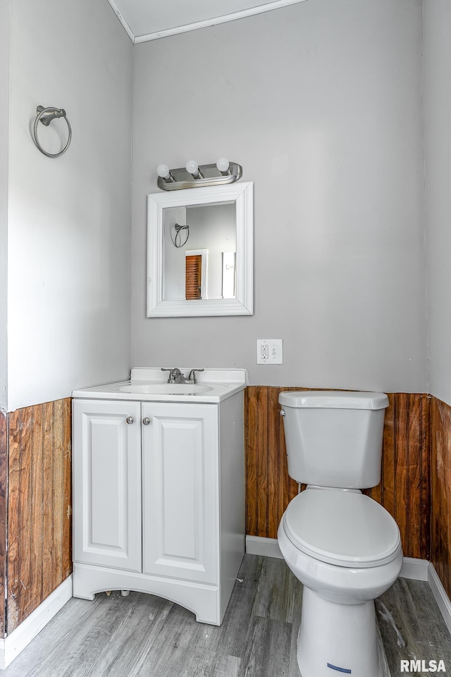 bathroom featuring vanity, toilet, and hardwood / wood-style flooring