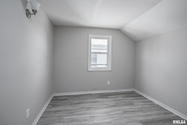 bonus room featuring vaulted ceiling and light hardwood / wood-style floors