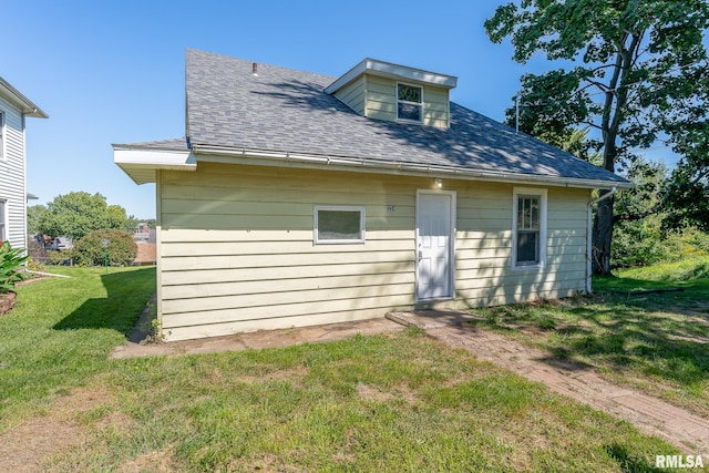 rear view of property with a yard