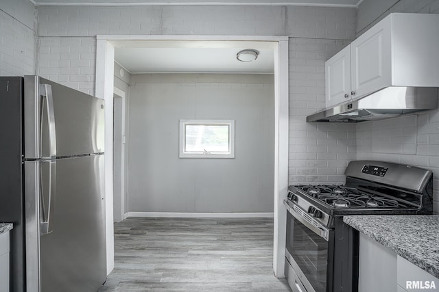 kitchen with light wood-type flooring, stainless steel appliances, and white cabinetry