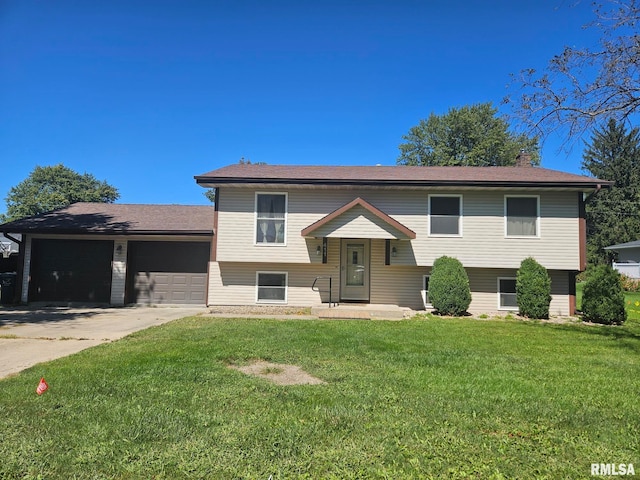 bi-level home featuring a garage and a front lawn