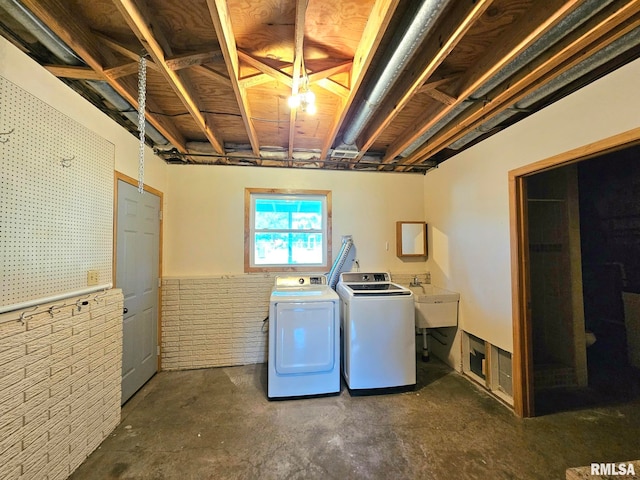 laundry room featuring sink and separate washer and dryer