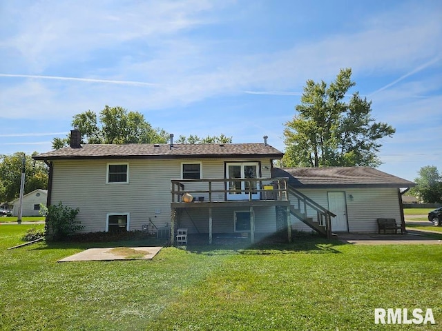 rear view of house with a patio area, a yard, and a deck