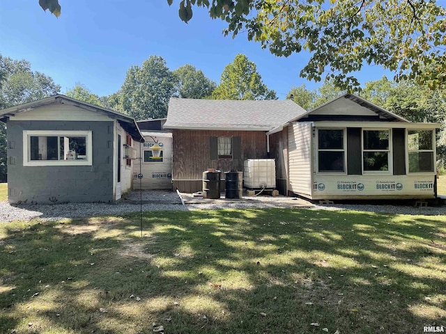 rear view of house with a yard