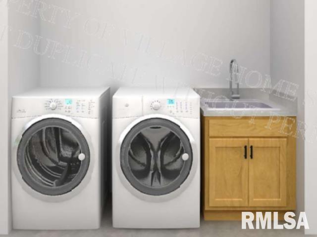 laundry area featuring sink, washer and dryer, and cabinets