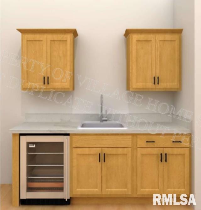 kitchen featuring light brown cabinets, beverage cooler, and sink