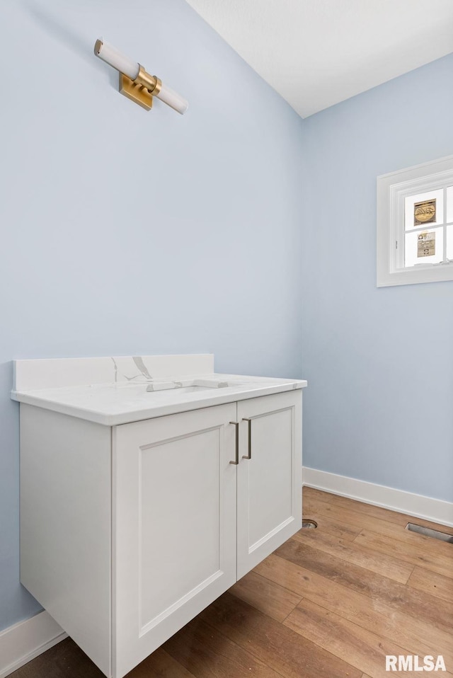 laundry room with light hardwood / wood-style floors