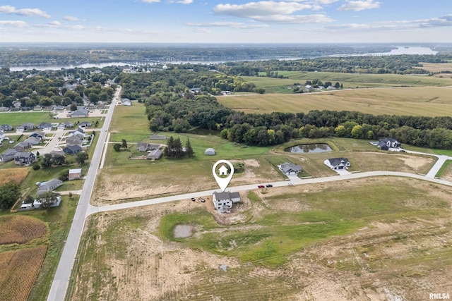 birds eye view of property with a water view and a rural view