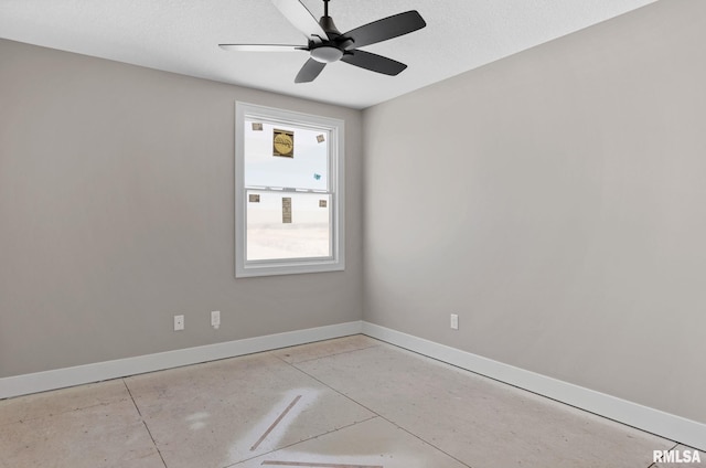 empty room featuring ceiling fan and a textured ceiling