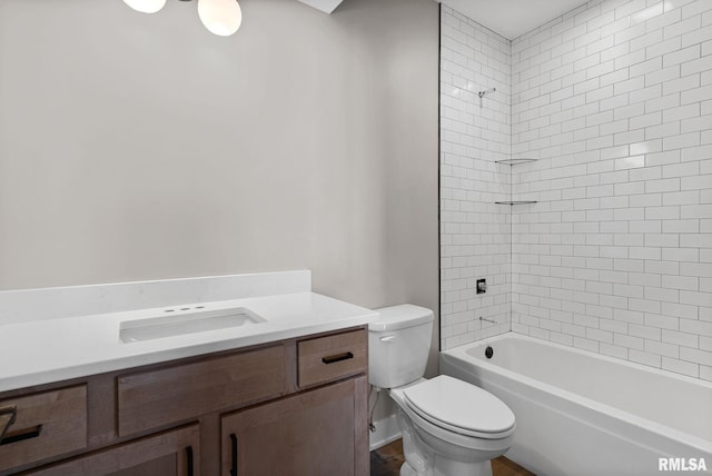 full bathroom featuring toilet, vanity, and tiled shower / bath combo