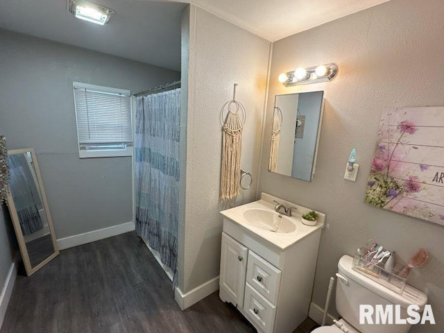 bathroom featuring a shower with curtain, toilet, wood finished floors, baseboards, and vanity