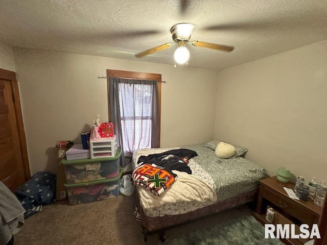 carpeted bedroom with ceiling fan and a textured ceiling