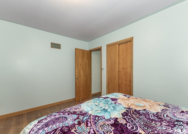 bedroom featuring a closet and hardwood / wood-style flooring