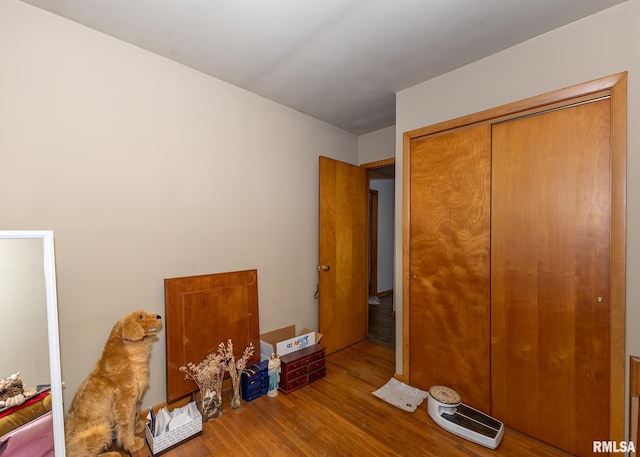 unfurnished bedroom with a closet and hardwood / wood-style floors