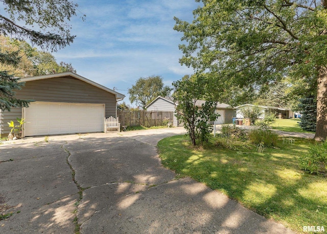 ranch-style home featuring a front yard and a garage