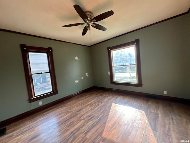 empty room with crown molding, hardwood / wood-style floors, and ceiling fan