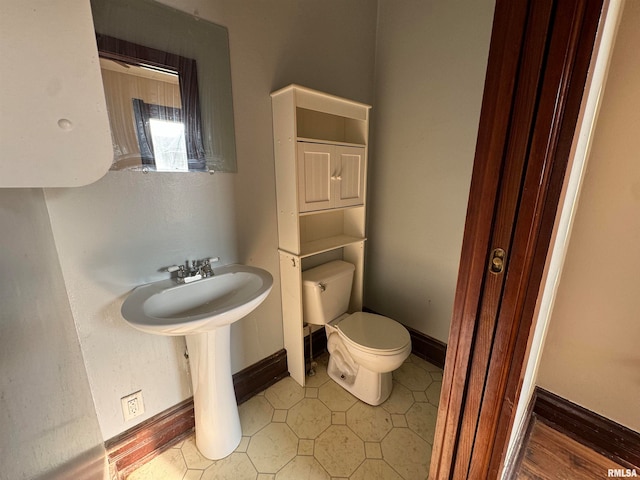 bathroom with toilet and hardwood / wood-style floors