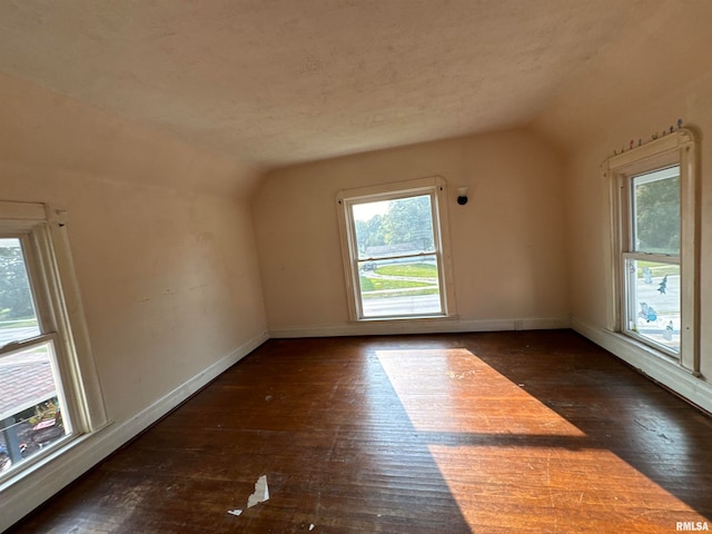 bonus room with dark hardwood / wood-style flooring and lofted ceiling