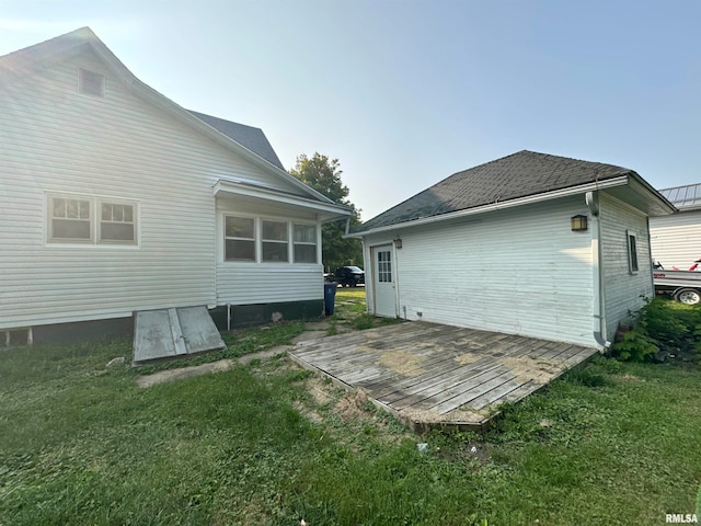 rear view of house with a yard and a wooden deck