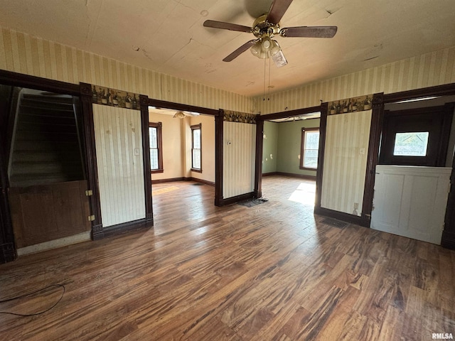 unfurnished room featuring dark wood-type flooring and ceiling fan