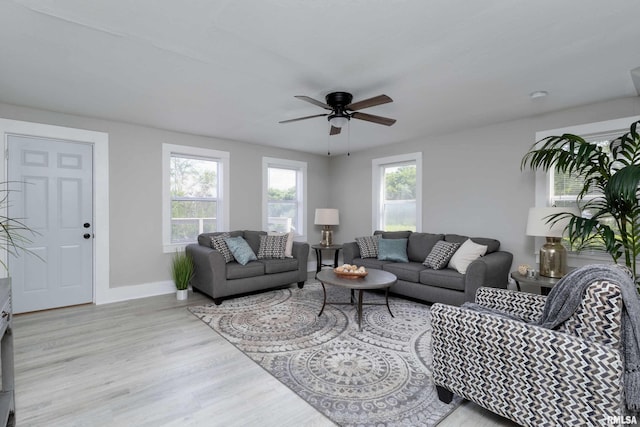 living room with light hardwood / wood-style flooring and ceiling fan