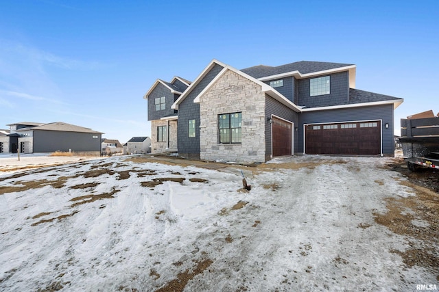 view of front of home featuring a garage and stone siding