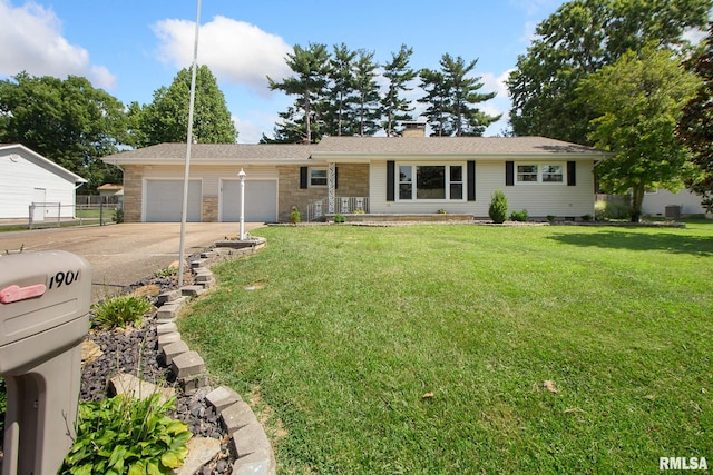 ranch-style house featuring a garage and a front yard