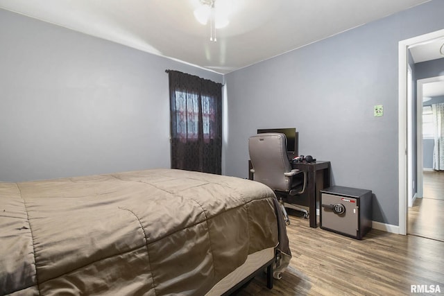 bedroom with ceiling fan and hardwood / wood-style flooring