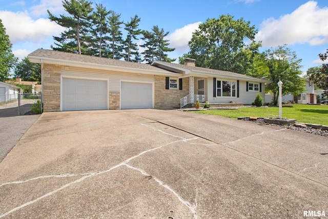 ranch-style home with a garage and a front lawn