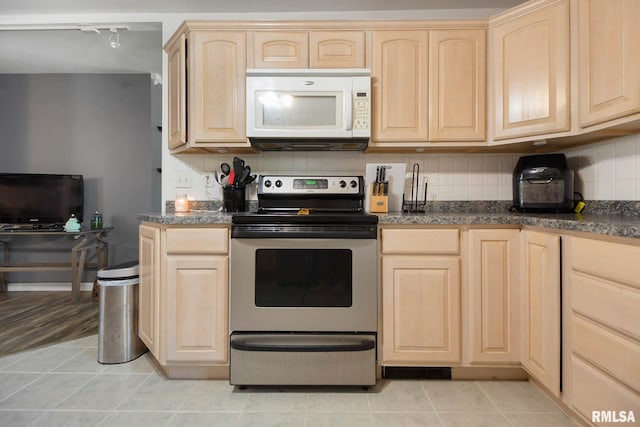 kitchen featuring stainless steel electric range, light brown cabinetry, light tile patterned floors, and backsplash