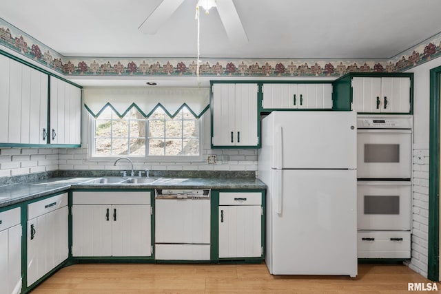 kitchen with white appliances, light hardwood / wood-style floors, sink, ceiling fan, and white cabinets