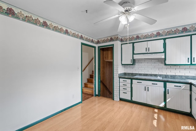 kitchen with white cabinets, ceiling fan, decorative backsplash, and light hardwood / wood-style flooring