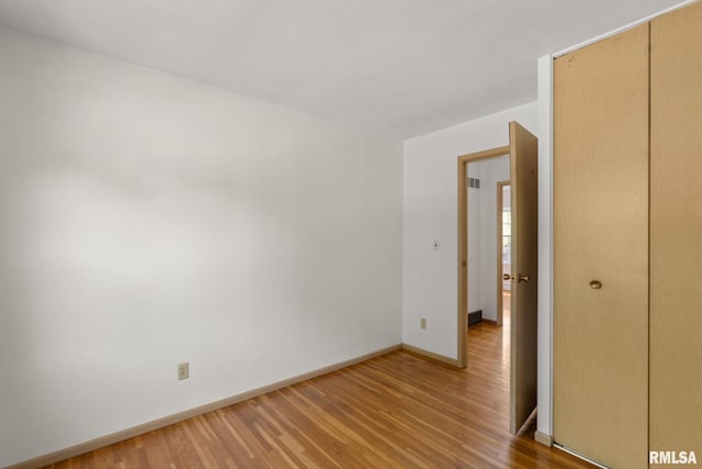 spare room featuring wood-type flooring