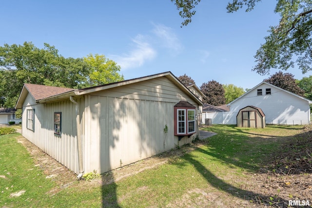 view of property exterior featuring a yard and a storage unit