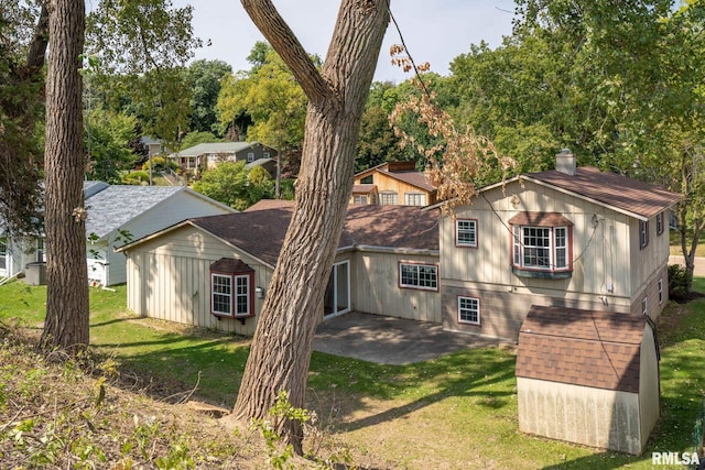 back of house featuring a yard and a patio