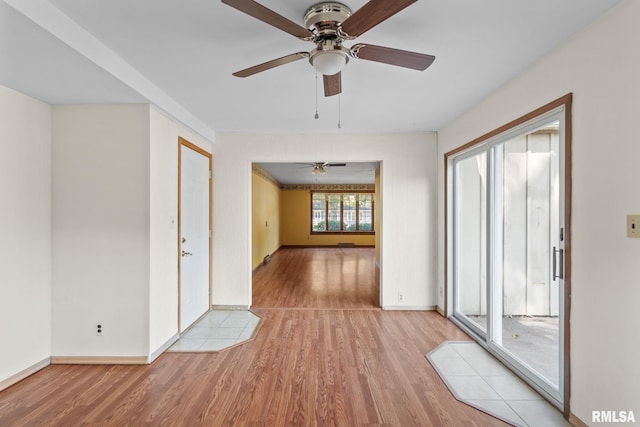 spare room featuring ceiling fan and light hardwood / wood-style floors