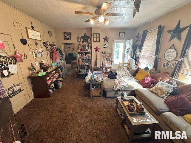 living room with dark carpet and ceiling fan