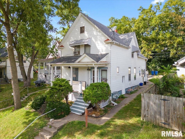 view of front of home with a front yard and covered porch